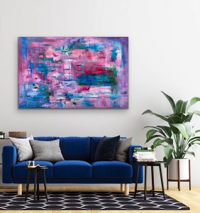 Passionately Soulful By Red, a Large acrylic abstract with vibrant pinks and blues displayed over a blue couch, a 40" x 60" gallery wrap canvas