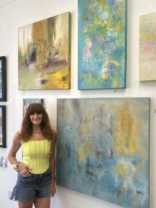Red with Her Artwork at the HUB New Smyrna