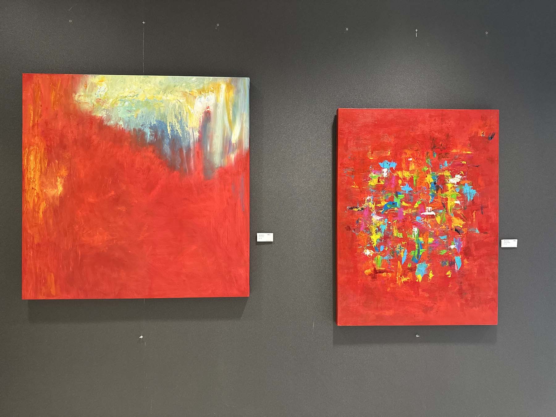 Two large red abstracts by Red on a charcoal feature wall in the Citrus Center lobby, Orlando