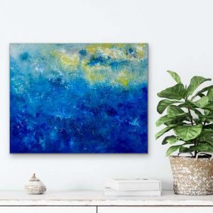 Blue Skies is a small oil abstract by Red hung over a white cabinet