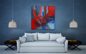 Large Bold Acrylic abstract featuring Reds and Blues hung on blue wall over white couch